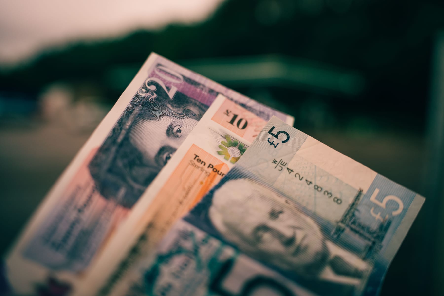 British five and ten pound notes close-up with blurred background